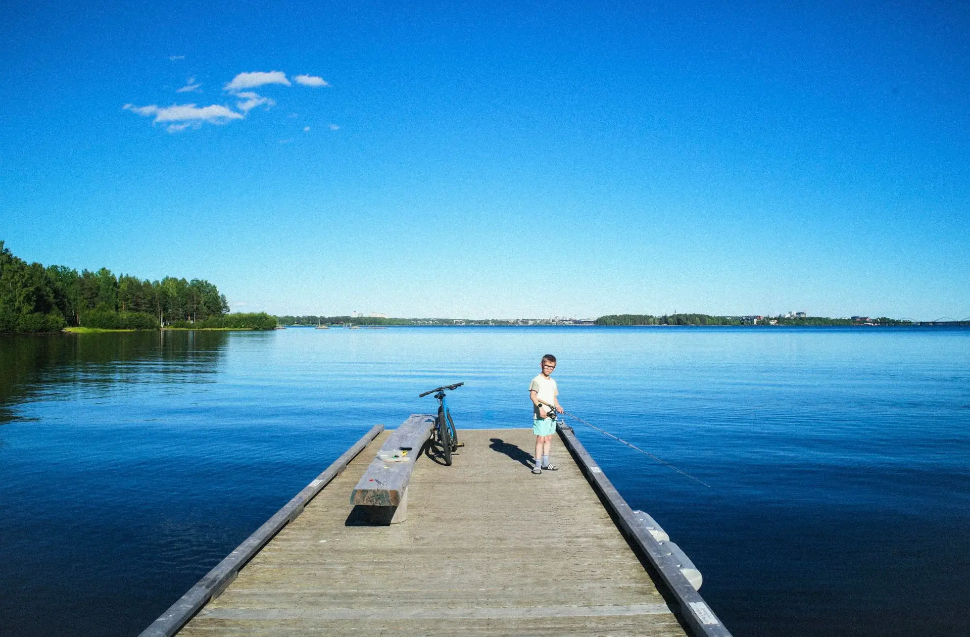 lulea ville balnéaire enfant près d'un lac qui pèche avec un vélo
